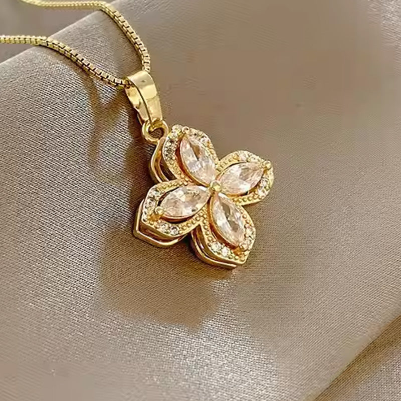 Halsband med roterande blomma och fyrklöver