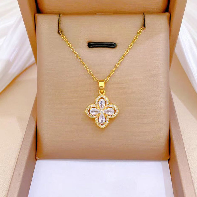 Halsband med roterande blomma och fyrklöver