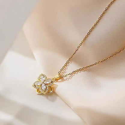 Halsband med roterande blomma och fyrklöver